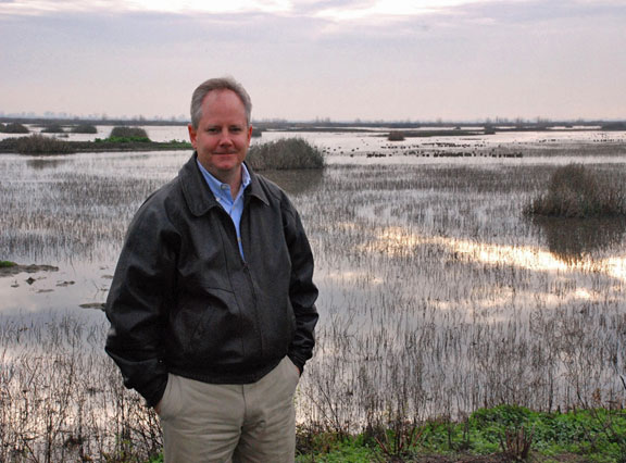 photo of John Donnelly with wetlands in the background